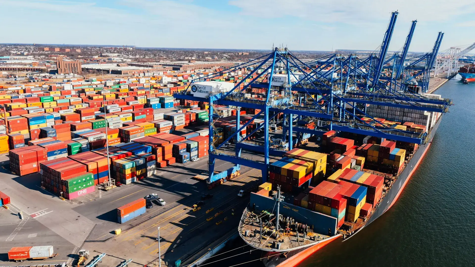 Container terminal with gantry cranes loading a cargo ship