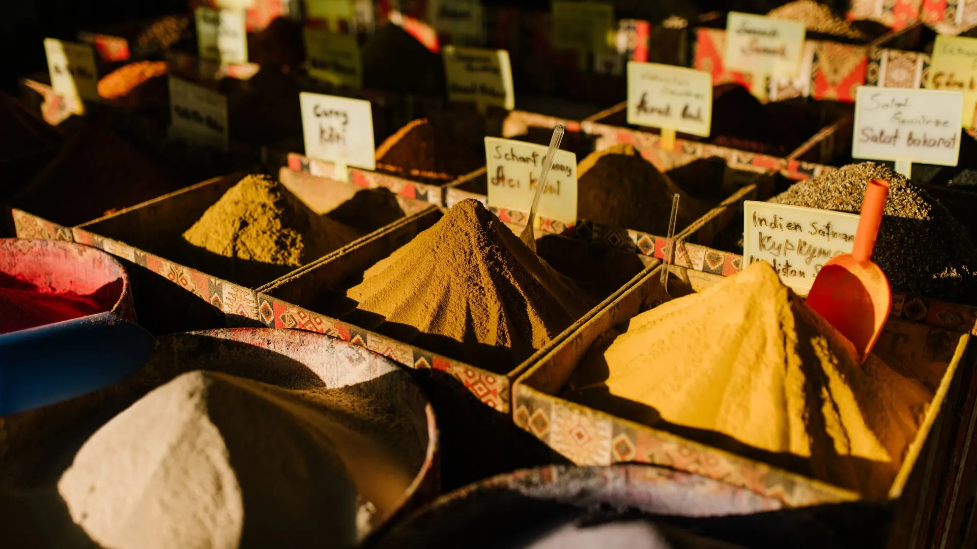 Spices in bulk at a market: turmeric, curry and chilli powders